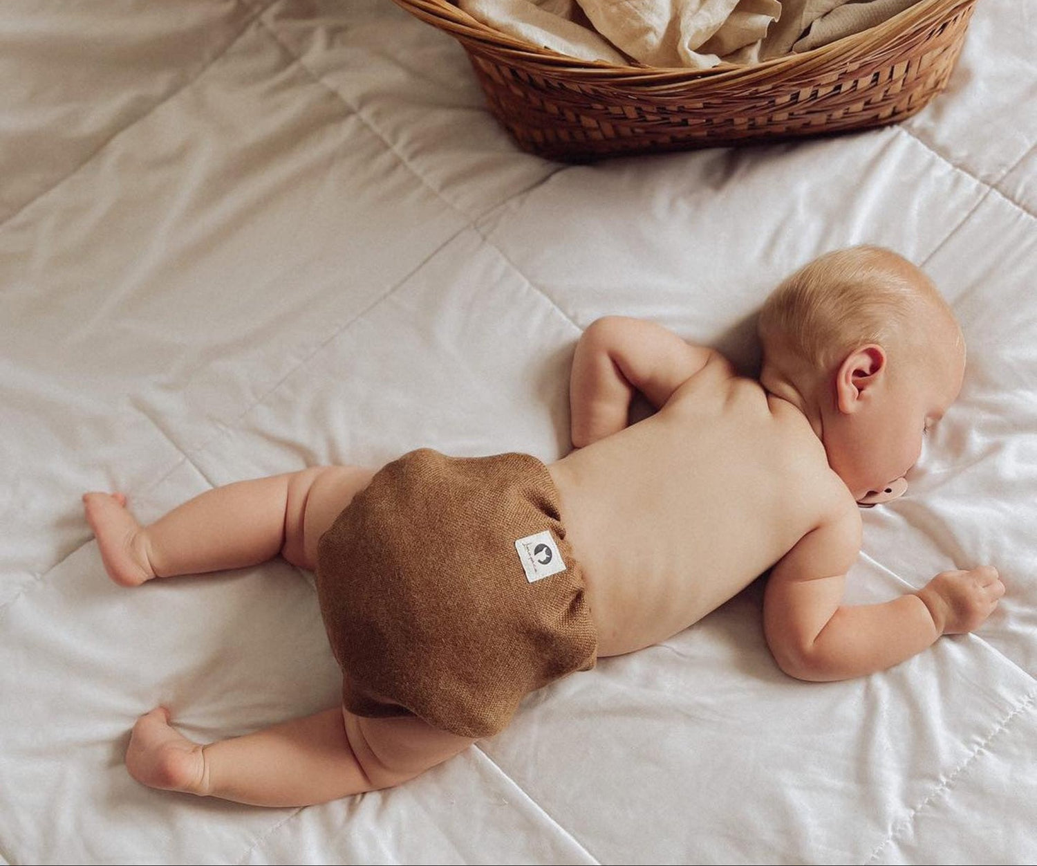 Sleeping baby wearing Lunapaca plastic-free Alpaca diaper cover.